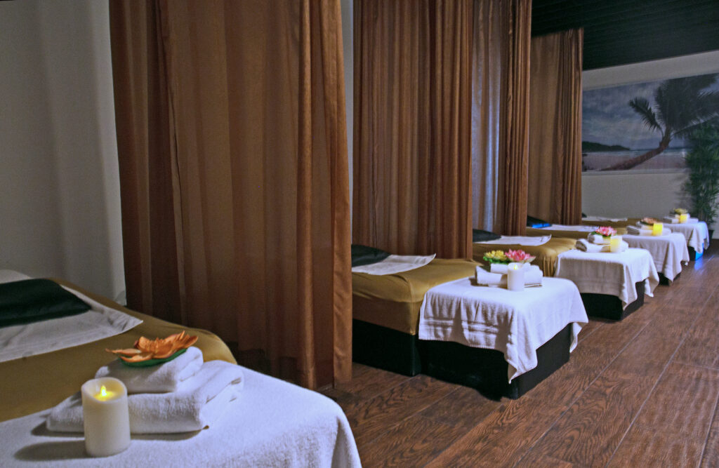 Spa treatment room with brown curtains and massage table